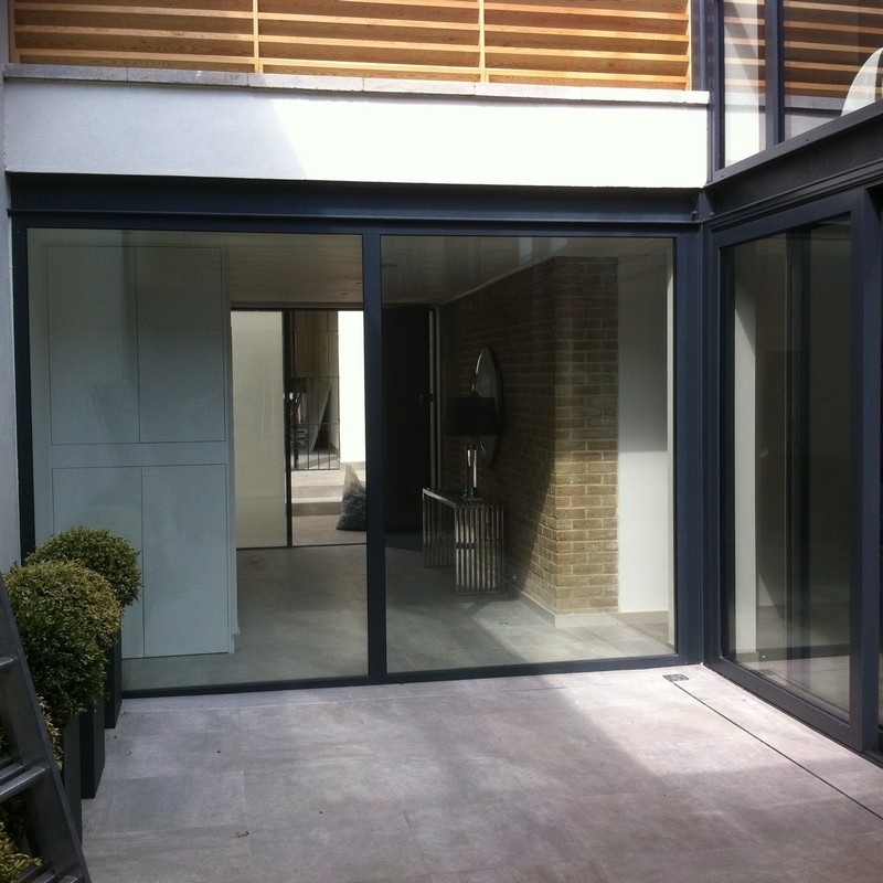 Floor-to-ceiling sliding doors opening to courtyard in Shepherd's Bush