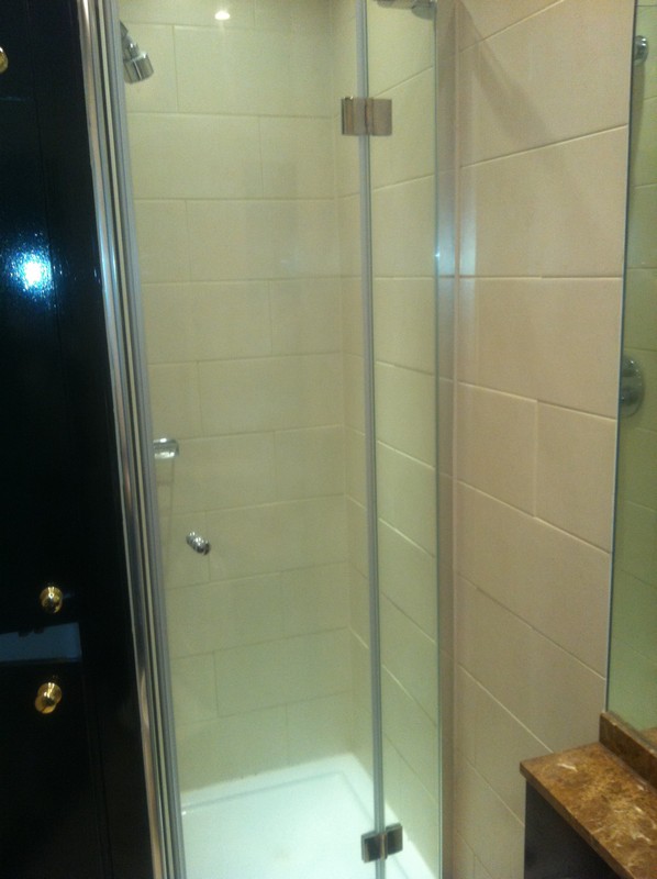 Frameless glass shower enclosure with chrome fittings in Shepherd's Bush