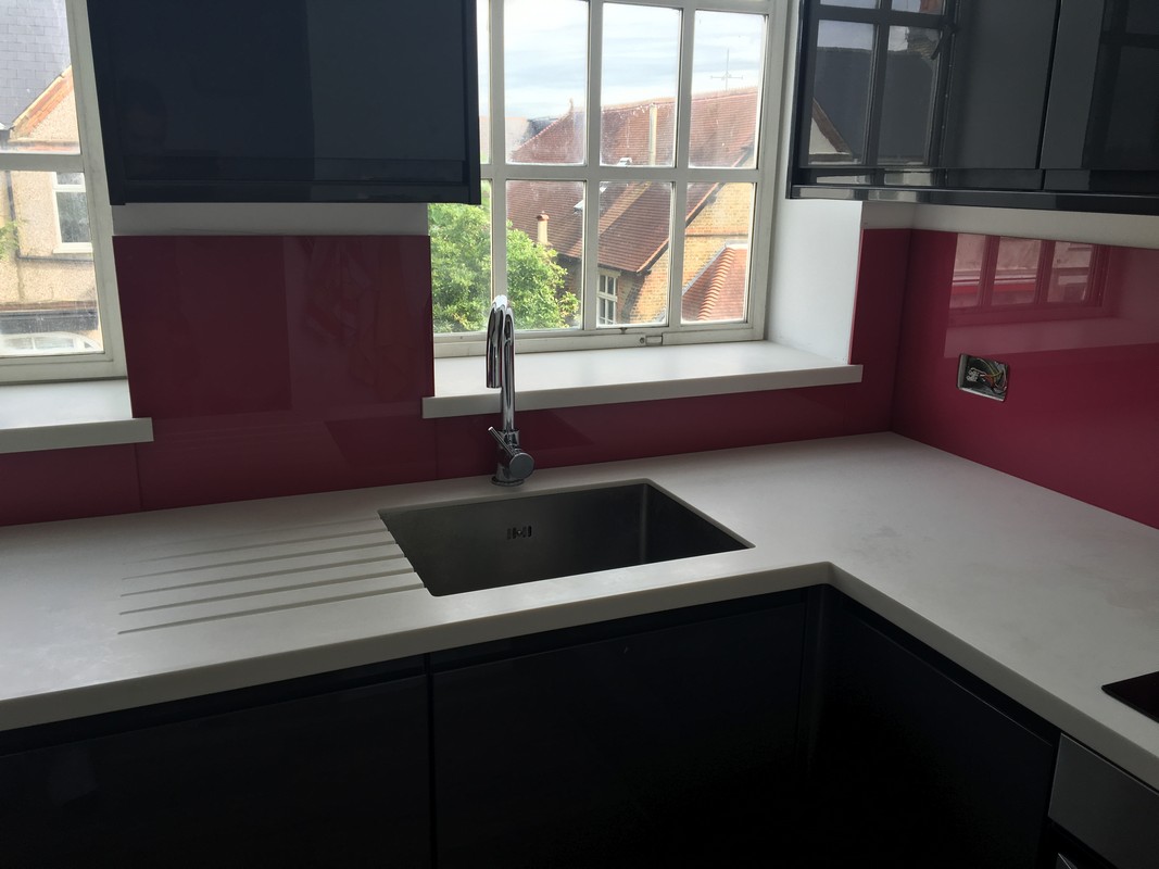 Deep plum coloured glass splashback in modern Shepherd's Bush kitchen